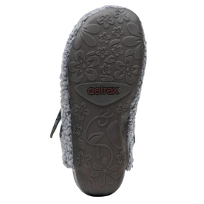 Close-up of a shoe sole with floral patterns and Aetrex branding on a white background