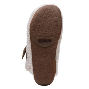Close-up of a sandal sole with floral patterns and 'Aetrex' branding on a white background