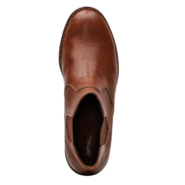 Brown leather shoe with 'Aetrex' branding on a white background