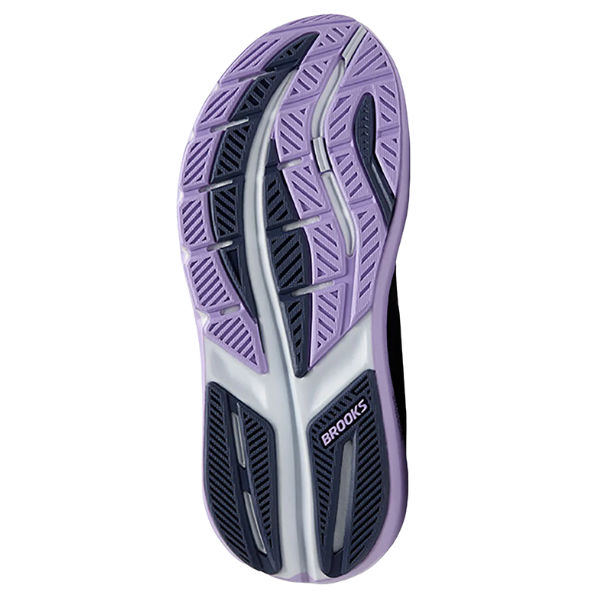 The image displays the sole of the Brooks Women's Ghost Max 3 in Night Shadow/Ebony/Purple, a cushioned road running shoe with purple, black, and white tread. Various grooves provide grip, and the BROOKS logo is visible near the heel.
