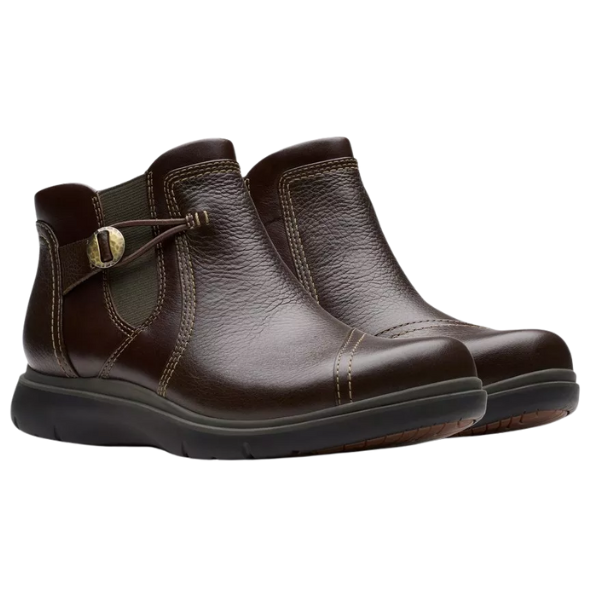 The Clarks Women's Certina Joy Wide Brown boots feature side buckles, elastic panels, and visible stitching. These comfortable leather boots by CLARKS are shown against a white background.