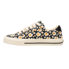 The TAOS Taos Women's Z Soul Daisy Black is a low-top canvas sneaker with a white sole, cream laces, and a black daisy floral pattern. It offers arch support for added comfort.