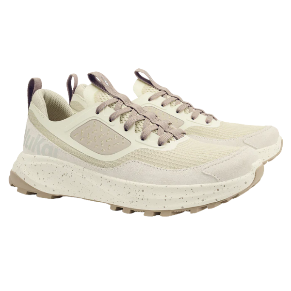 The OLUKAI Women's Makiki Lava White Sand trail running shoes feature textured soles, breathable mesh uppers, taupe laces, speckled midsoles, and a heel tab for easy wear—ideal for all-terrain performance.