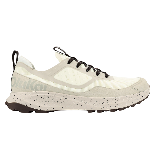The OLUKAI Men's Makiki White is a beige and white athletic sneaker with a speckled off-white sole, black laces, and a black heel pull tab, delivering lightweight, breathable comfort for all-terrain performance. Displayed against a white background.
