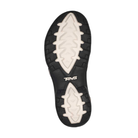 The image shows the sole of the TEVA Women's Tirra Black/Birch Multi sandal with a black edge, white textured zigzag for traction and arch support, and the TEVA logo near the arch.