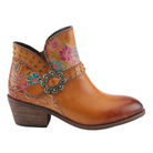 The SPRING STEP Women's Daintylady Boot Camel is a brown leather ankle boot with embossed pink and turquoise floral patterns, gold studs, a decorative buckle, and a low heel for classic western flair.