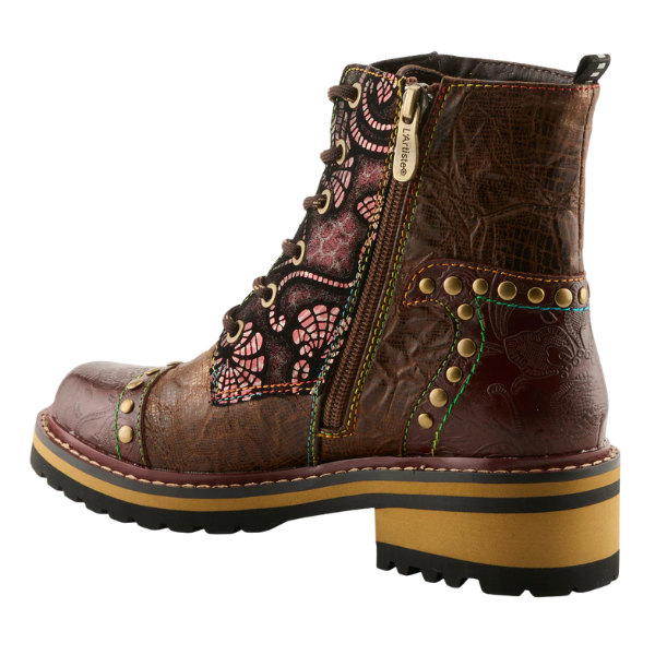 The Spring Step Women's Rugup Brown Multi by SPRING STEP is a stylish ankle boot with a chunky heel, brown faux leather, colorful patchwork, metal studs, side zipper with “L’Artiste” tag, and a black sole with tan accent.