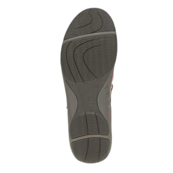The image shows the bottom view of a single Dankso Women's Stacy Red shoe with a gray, textured rubber sole featuring wavy tread patterns for grip. The sole has "DANSKO" embossed in the center, highlighting its slip-resistant design.