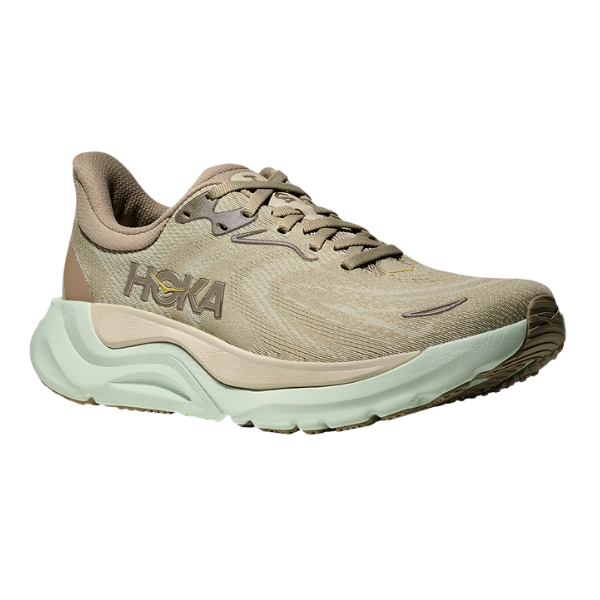The HOKA Women's Arahi 8 Oyster Mushroom is a beige and light green running shoe with a cushioned sole, breathable mesh upper, and HOKA logo—designed for stability and support, ideal for runners or those with plantar fasciitis.