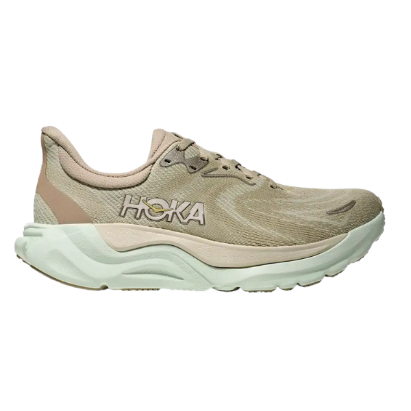 The HOKA Women's Arahi 8 Oyster Mushroom is a beige and light green stability running shoe with a thick cushioned sole for plantar fasciitis, mesh-like upper, and the HOKA logo on the side, shown in profile view.
