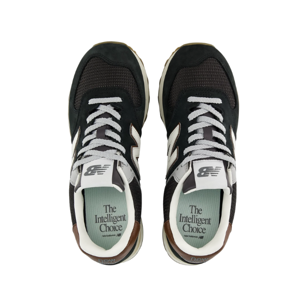 A pair of brown/silver New Balance Men's 574 sneakers viewed from above, with The Intelligent Choice on the insoles.