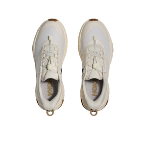 A pair of HOKA Women's Transport 2 Wide Alabaster running shoes, viewed from above on a white background.