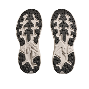 HOKA Women's Challenger 8 Stucco/Asphalt trail shoes with rugged textured outsoles shown from the bottom.