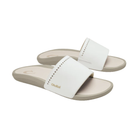 OLUKAI Women's Ulele Slide White sandals with white straps, gold logo, and supportive footbed.