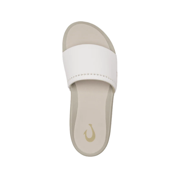 Top view of the OLUKAI Women's Ulele Slide White with a supportive footbed and gold fishhook logo on a white strap.