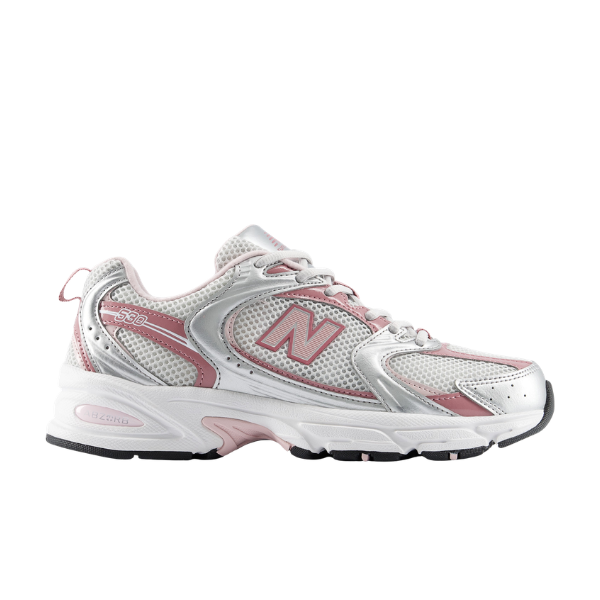 The NEW BALANCE Women's 530 Silver/Rose Wide is a mesh-paneled running shoe with a thick rubber sole, seen from the side.