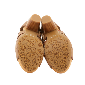 The soles of SPRING STEP SpringStep Women's Icon Tan heeled sandals have engraved floral patterns.