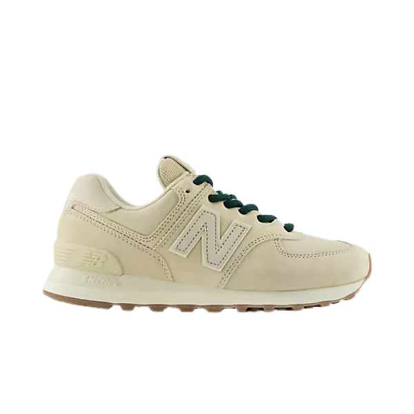 New Balance Women's 574 Tan sneakers with green laces, N logo, and light brown sole, side view.