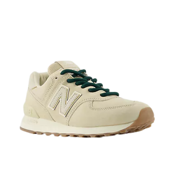 NEW BALANCE Women's 574 Tan sneakers with dark green laces, white N logo, and gum sole on a white background.