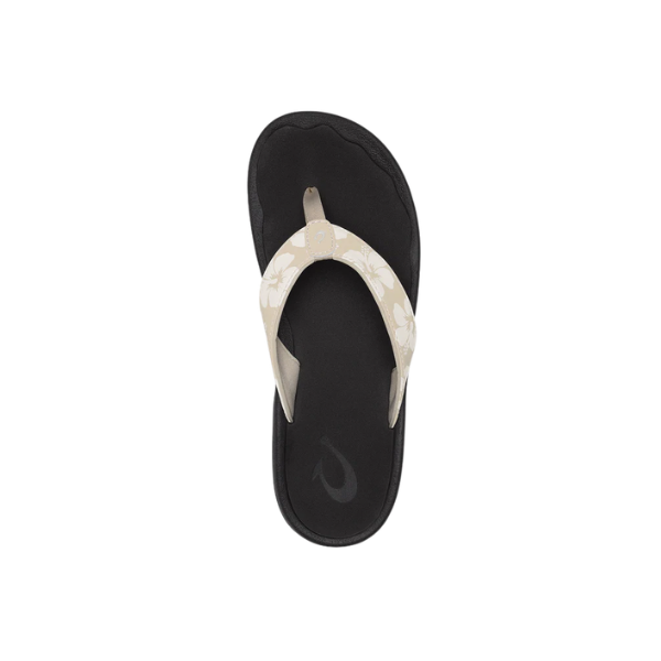 OLUKAI Women's Ohana Tapa sandal with beige floral-patterned straps, viewed from above on a white background.