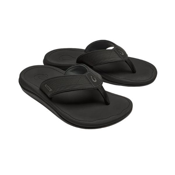 OLUKAI Men's Ahi Kai Black/Black sandals feature thick straps and wet-grip soles, ideal for ocean adventures.