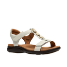 Clarks Women's Kitly Gem Wide White sandals with a tan cushioned footbed, black sole, and gold front strap accents.