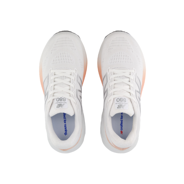 The NEW BALANCE Women's 880 V15 in white/orange features Fresh Foam X cushioning and a top-down view.