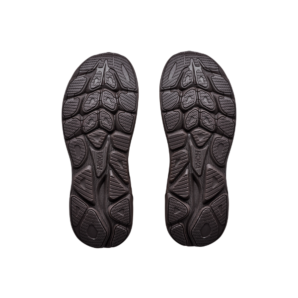 Pair of brown textured shoe soles shown from below, ideal for HOKA Men's Clifton 11 running shoes.