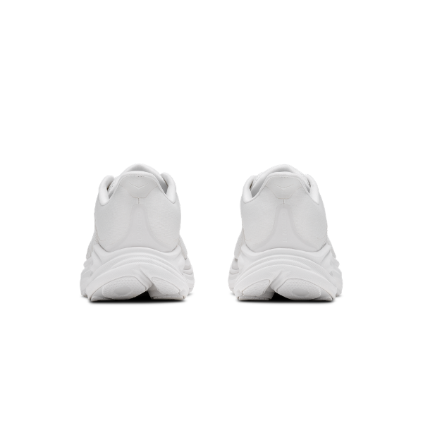 Two wide white HOKA Women's Clifton 11 running shoes shown from the back on a plain background.
