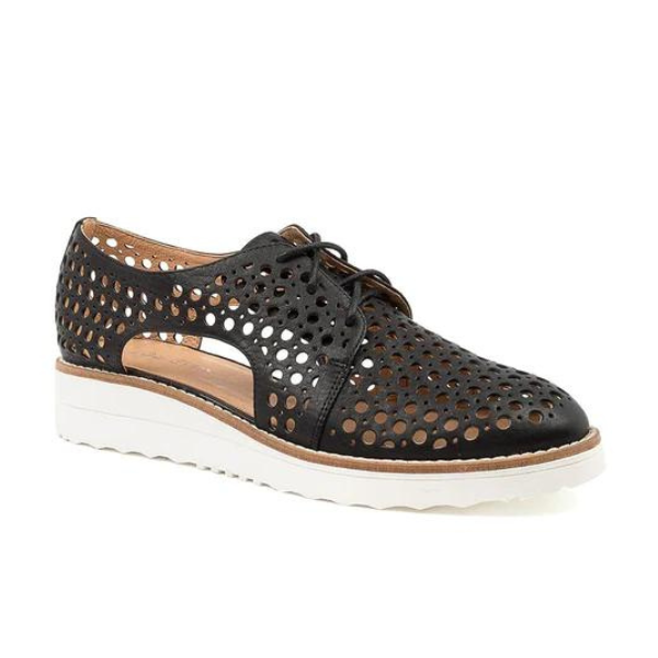 The Django & Juliette Womens Onstage Black Leather by DJANGO & JULIETT is a black leather lace-up oxford with a white sole, perforated design, and side cutouts for breathable style—ideal for effortless athleisure chic.