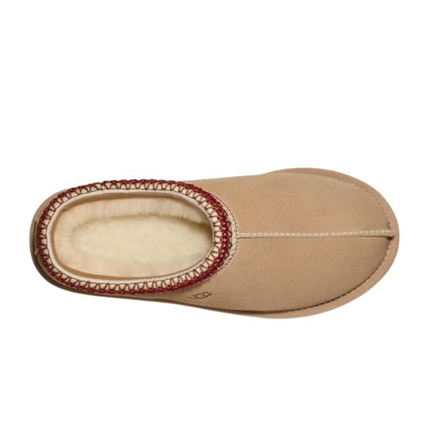 Top view of the UGG Womens Tasman Slipper Sand/Dark Cherry, showing tan suede uppers, cream wool lining, and red decorative stitching around the opening, displayed on a white background.