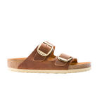 The Birkenstock Womens Arizona Big Buckle Cognac features two Wide oiled nubuck leather straps with large gold buckles, a cork-latex footbed, beige rubber outsole, and signature BIRKENSTOCK comfort.