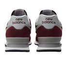 Two New Balance Unisex 574 Magenta running shoes are shown from the back, featuring "new balance" on each heel. They have white midsoles and textured outsoles, ideal for comfort and foot pain relief.