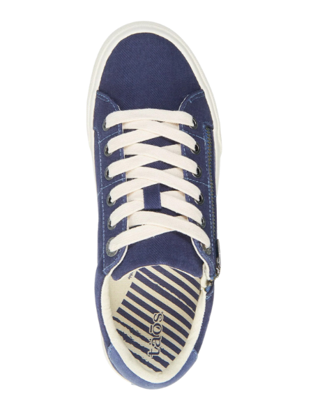 Top view of the Taos Womens Z Soul Navy/Indigo Distressed sneaker by TAOS, featuring blue canvas, white laces and sole, a beige and blue striped insole with the TAOS logo near the heel, and built-in arch support.