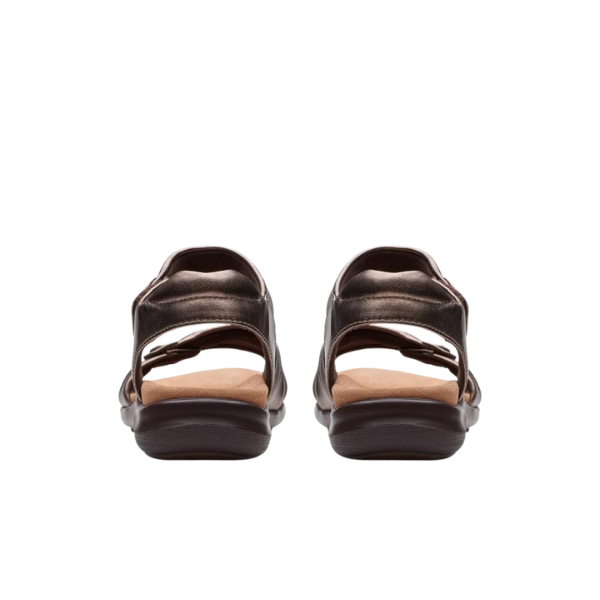 A pair of Clarks Womens Kitly Ave Bronze sandals, seen from the back with adjustable Wide straps and cushioned Contour Cushion footbeds, shown against a plain white background.