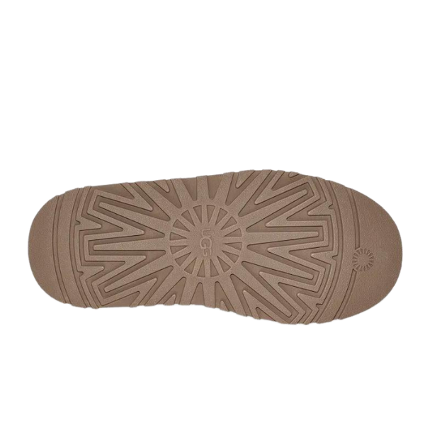 A chestnut brown rubber sole for UGG Womens Tazz Slippers features geometric tread, radiating lines, and UGG embossed in the center. The platform outsole offers enhanced grip and style.