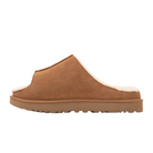 The UGG Women's Greenport Slide Chestnut is a brown suede open-back slipper with a fuzzy white lining and thick rubber sole, offering classic indoor-outdoor comfort. Shown in side view against a white background.