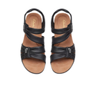 A pair of CLARKS Womens Wide Kitly Ave Black Leather sandals with three crisscross adjustable straps, open toes, and tan Contour Cushion footbed insoles, shown from above on a white background.