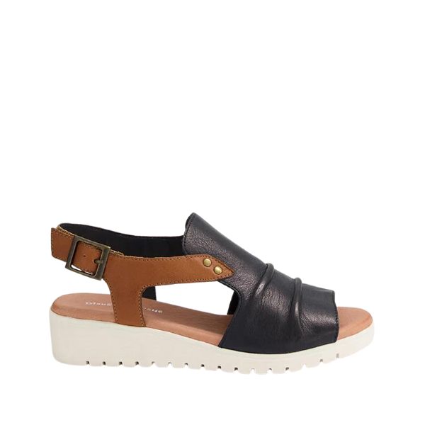 The Django & Juliette Womens Madis Navy/Tan Leather sandal features a comfortable low white wedge sole, navy pleated leather upper, tan strap with gold buckle, and an open toe and heel—stylish relief for foot pain.