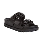 The Django & Juliette Womens Ubey Black Leather slide sandal features two broad straps with chunky chain-link accents and a thick ridged sole—combining stylish design with supportive comfort for sensitive feet.