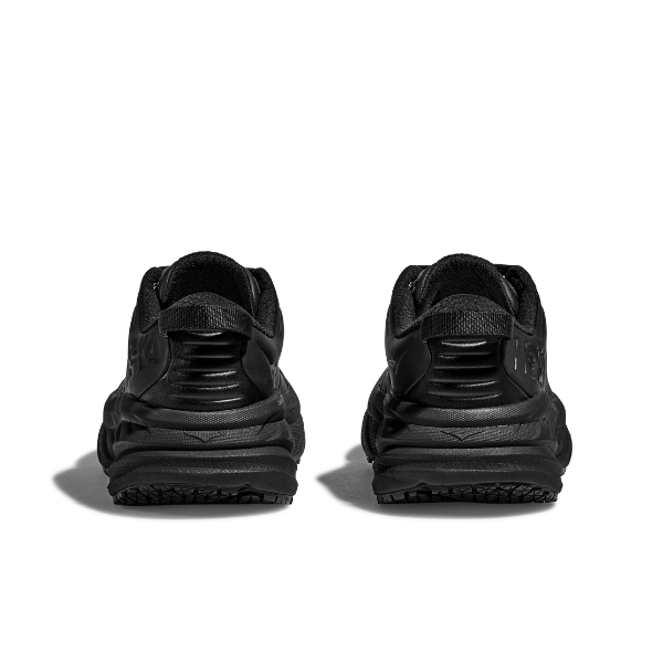 A pair of HOKA Mens Bondi SR Wide sneakers in black are shown from the back on a white background, highlighting their cushioned design, detailed heels, and slip-resistant outsole.