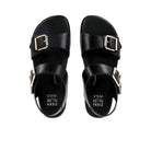 The Ziera Womens Hastice Black Leather sandals by ZIERA feature Wide straps and large gold buckles, seen from above. The Pillow Walk insole delivers plush foam cushioning for all-day comfort.