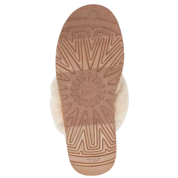 UGG Women's Cozy Cream features a geometric tread sole and visible fur with a plush sheepskin lining.