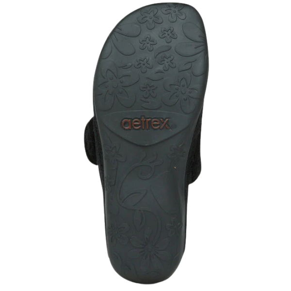 The sole of the Aetrex Women's Mandy Black sandal features a floral pattern and the brown AETREX brand name.