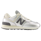 The New Balance Women's 574 in Metallic Silver/Arctic Grey features a gray N logo and black sole for stylish comfort.