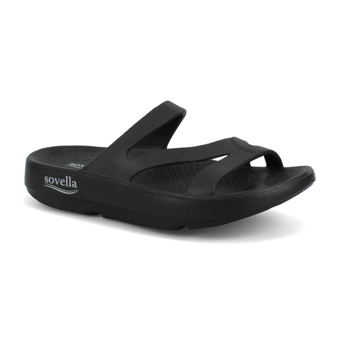 The Sovella Women's PF Slide Black is a slip-on recovery sandal with two wide straps, an open toe design, cushioned comfort, and the SOVELLA name in white on the thick sole.
