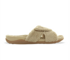 The Strive Womens Zoey Nude slipper by STRIVE features a beige, open-toe design with a plush fuzzy upper, thick foot strap, cushioned sole in a deeper beige shade, and built-in arch support for superior comfort.