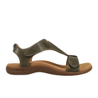 The Taos Womens The Show Olive sandal features premium olive green leather, a closed back, adjustable straps, and a beige cushioned antimicrobial footbed on a brown sole. taös branding appears near the heel.