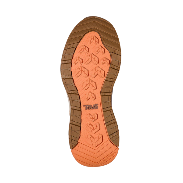 The image shows the sole of the Teva Womens Auroris boot in Feather Grey/Acorn, featuring an orange and brown pattern with angled grooves and Teva embossed at the center. This rugged, waterproof sole is designed for optimal traction.