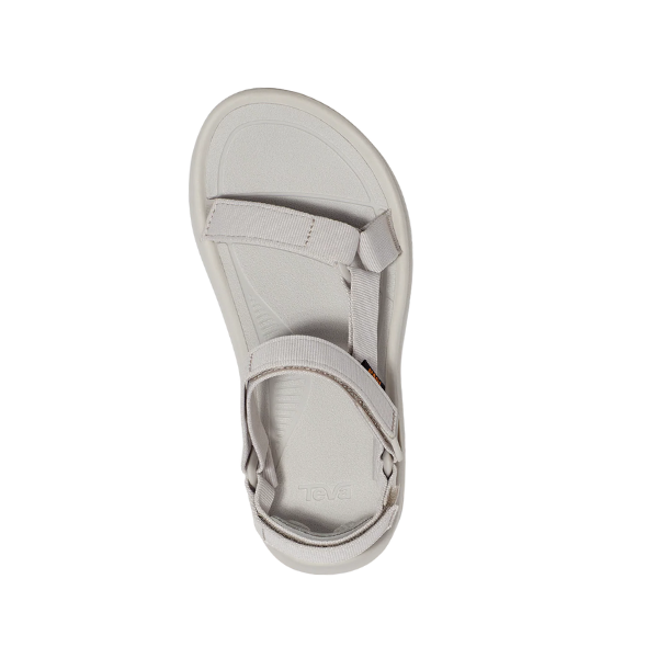 A single Teva Womens Hurricane XLT2 Ampsole Moonstruck sport sandal with adjustable fabric straps and a flat sole, made from recycled materials, shown in light gray from above on a white background.